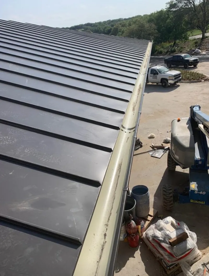 Standing seam panel and gutter detail on a metal roofing jobsite in Brandywine